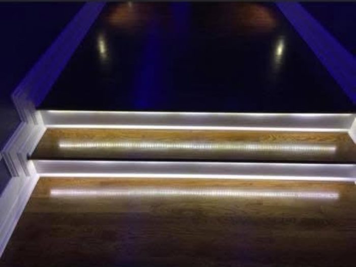 LED accent lighting installed under a staircase by TK Electric