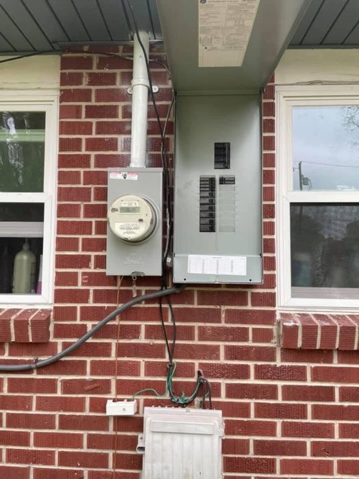 Meter and panel installed under a brick home's porch by TK Electric